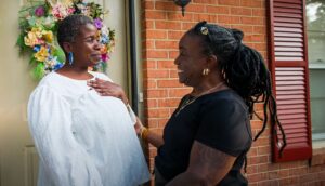 A Catholic Charities client and her mentor smile together